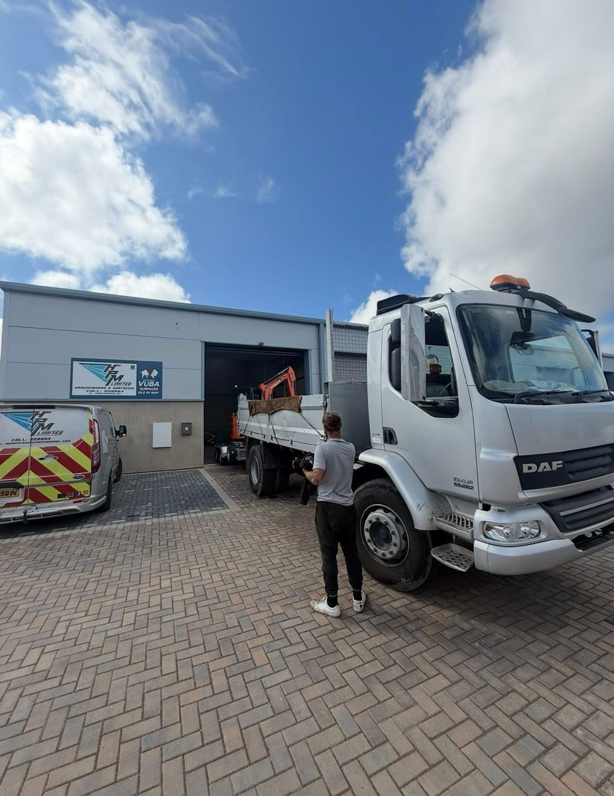 HPM Groundworks fleet — vans, trucks and DAF lorry at Isle of Man yard